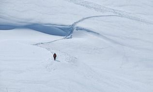 alone pedestrian at snowy mountain landscape