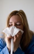 sick flu woman with a handkerchief in hands