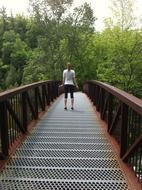 girl on a metal bridge over the river