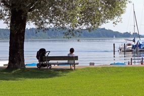 young mother with a stroller on the waterfront