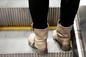 escalator boots legs in black pants