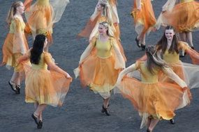 girls dance in orange dresses