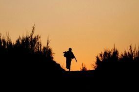 silhouette of a woman at orange sunset