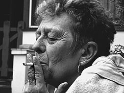 Black and white photo of the woman smoking cigarette