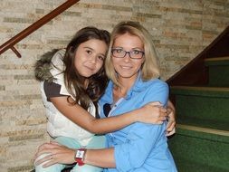 photo of mom and daughter on a wooden staircase