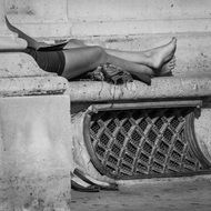 woman is resting on a street in Paris