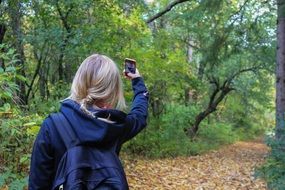 girl makes selfie in the forest