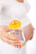 pregnant woman with feeding bottle