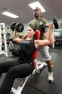 woman in gym with trainer