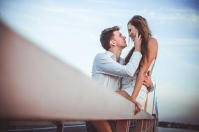 Couple of woman and male are on a pier