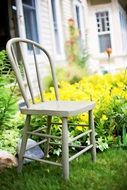 Vintage garden chair on green meadow
