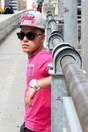 young man wearing a cap and pink T-shirt