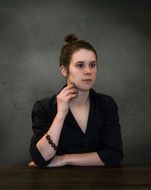 sitting young woman in black portrait