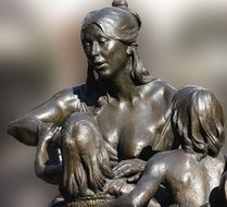 bronze sculpture of a woman with children