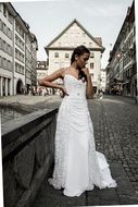 woman in white wedding dress on a street