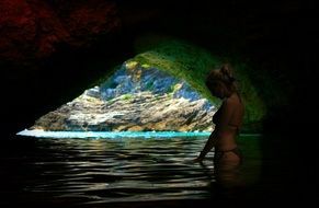 woman in the twilight of the ocean grotto