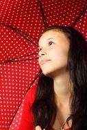 Girl and red umbrella in polka dots