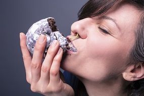 woman biting a cake