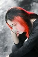 thoughtful asian lady with pink hair