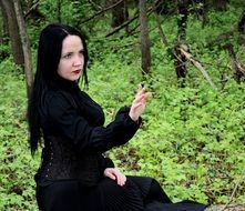 woman in gothic style in a green forest