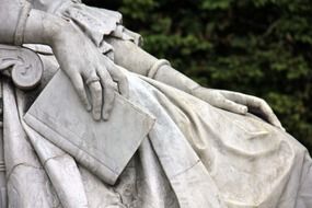 sculpture, hand with book