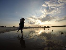 Kiss loving couple on the background of evening sky