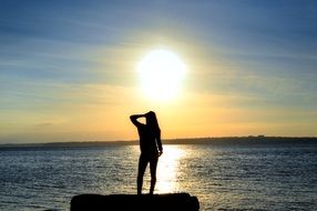 woman silhouette sea sunset scene