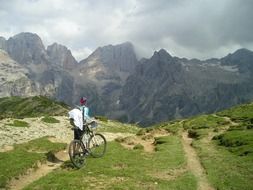 Lonely mountain biker watching great mountains