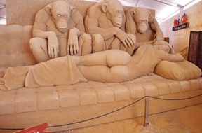 sand sculpture monkeys and woman artwork