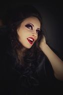 woman with vampire make up black aback