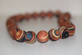 brown wooden beads close up on blurred background