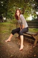 Young Woman without shoes on bench