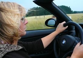 woman driving cabriolet car