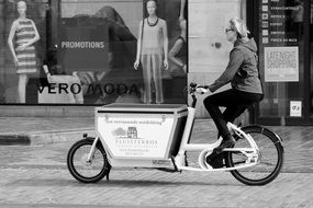 girl on a tricycle in the city