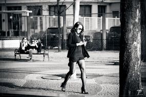 black and white photo of a girl who walks down the street