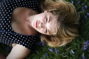 Girl is lying on the flowers