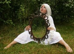 girl with white hair and a mirror