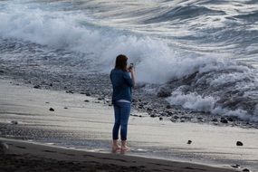 woman with a smartphone on the beach