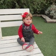 little girl with a red bow on her head