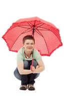 woman with an umbrella squatting
