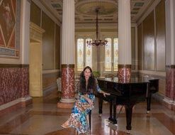 young woman at piano in luxury interior