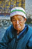 old woman in knitted hat in Thailand