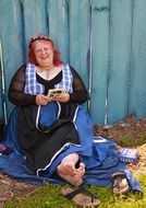 happy fortune teller near the blue fence