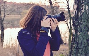 photographer woman making photo in Forest