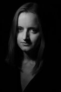 dark photo of a girl with long hair without emotions on her face