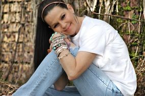 photo of a woman with a lot of bracelets on her arm