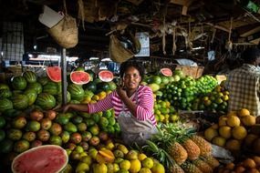 woman sells fruits on market, kenya, nairobi