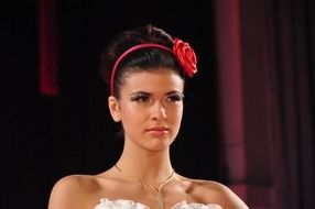 beautiful girl with a red flower on her head