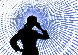 silhouette of a woman with a mobile phone on the background of communications waves
