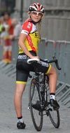 young blonde girl in cycling outfit with bicycle